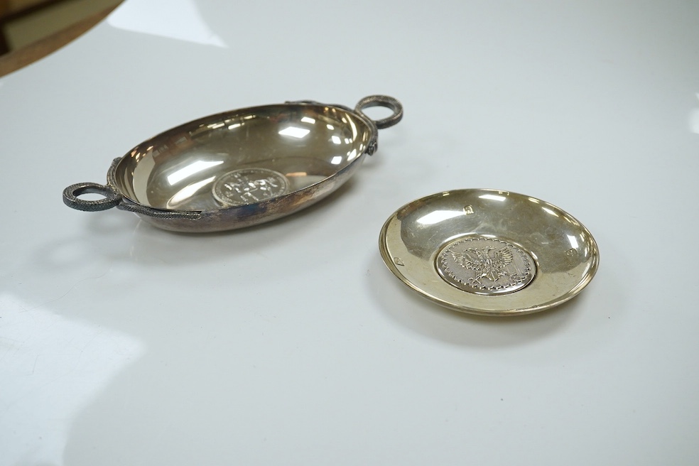 A 1970's Brittania standard silver commemorative small dish, C. Hoare & Co, London, 1972, 92mm, together with a German 925 oval dish with serpent handles and inset with coin, gross 8.9oz. Condition - fair